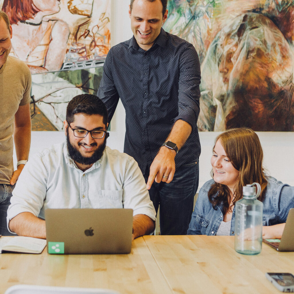 three men and one woman working together