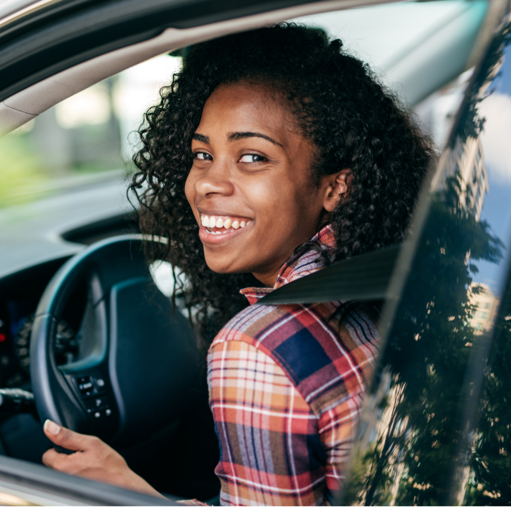 smiling woman in car