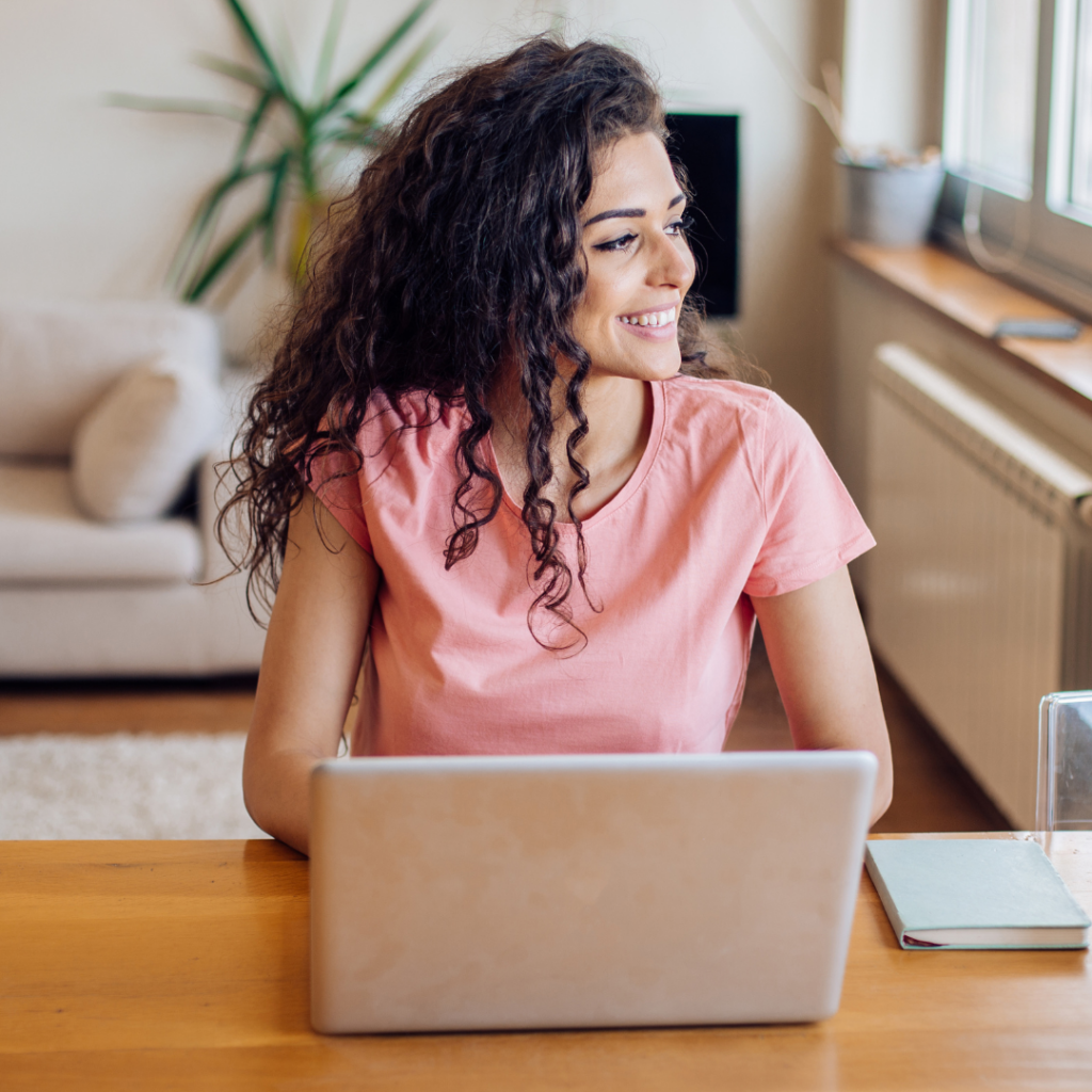 woman using laptop and smiling