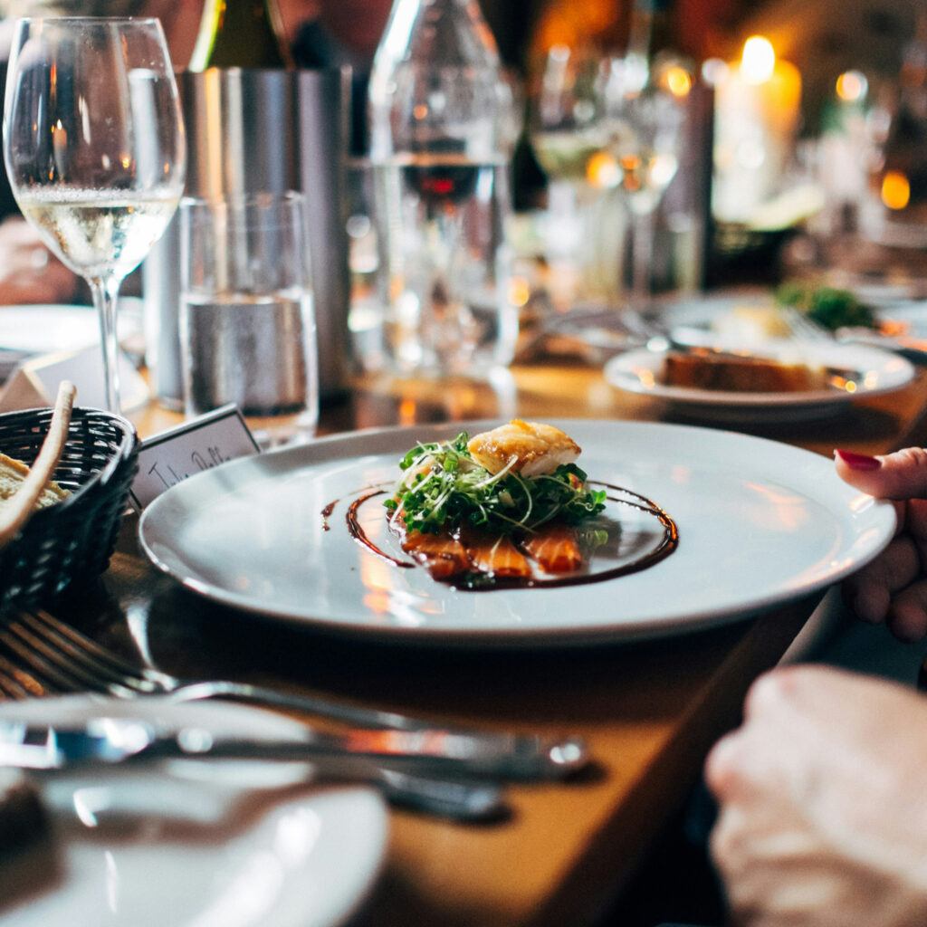 tablescape at a restaurant featuring a plate with food