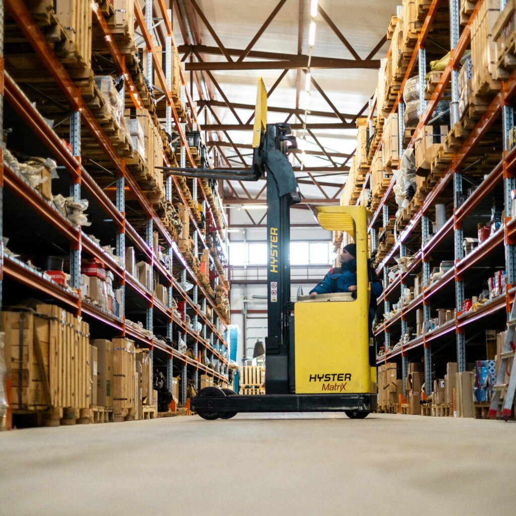 A person using a forklift in a warehouse