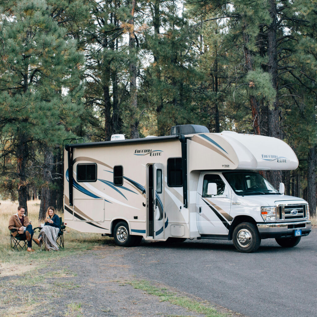 rv with people sitting in chair outside